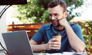 Homem assistindo webinar em computador. Imagem simboliza o participante assistindo o CIO Meet 2020.
