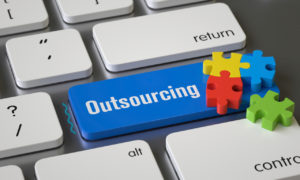 Tecla de computador chamada Outsourcing. Imagem simboliza o serviço Outsourcing de TI em tempos de pandemia.